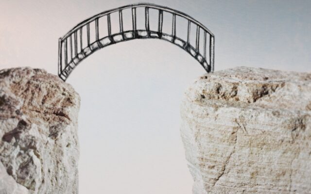 A bridge spanning a gap between two rocky cliffs representing the connection between evidence and conclusions.