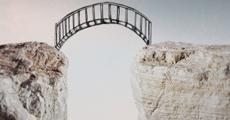A bridge spanning a gap between two rocky cliffs representing the connection between evidence and conclusions.